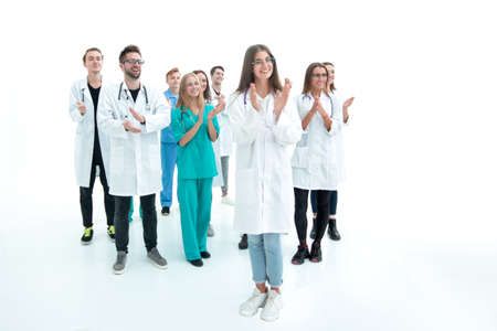 female doctor standing in front of her applauding colleaguesの写真素材