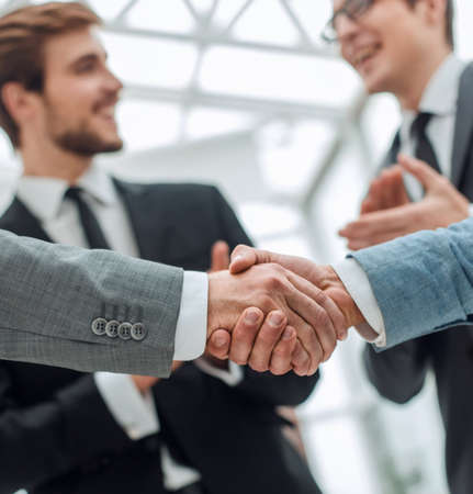 close up. business partners, confidently shaking hands