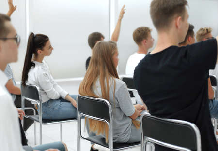 diverse young people applauding while sitting in the same row . photo with copy spaceの写真素材