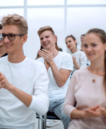 group of young people applaud at a group meeting