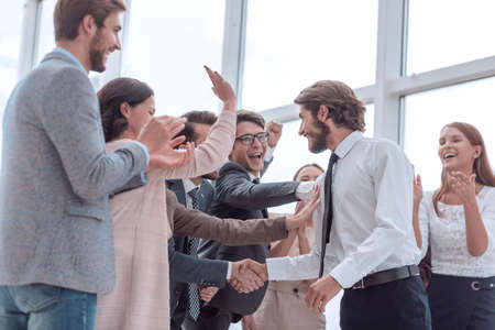 corporate group of employees congratulating each other on the victoryの写真素材
