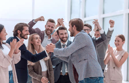 corporate group of employees congratulating their colleague.の写真素材