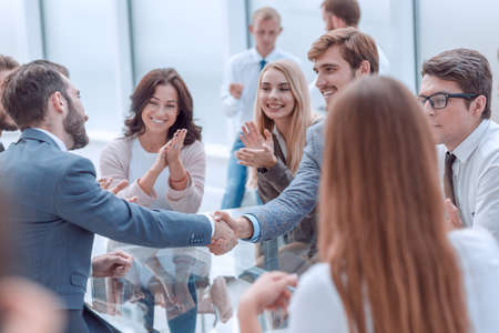 business team applauding the handshake of business partners.の写真素材