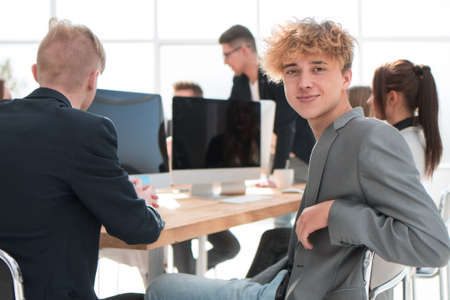 young employee sitting at a table during a work meeting.の写真素材