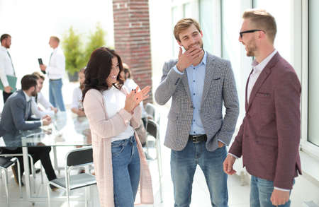 three young employees standing in a modern office.の写真素材