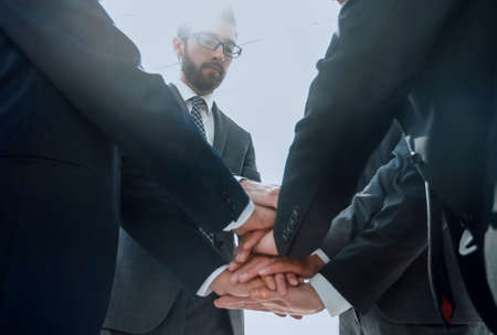 close up.business partners build a tower out of their handsの写真素材