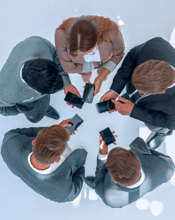 top view .business team using their smartphonesの写真素材