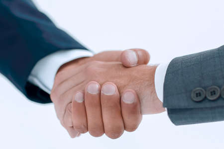 Closeup of business people shaking hands over a dealの写真素材