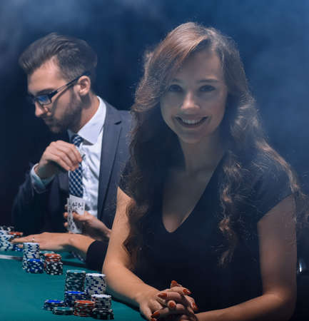 modern business woman sitting at craps table in a casino.の写真素材