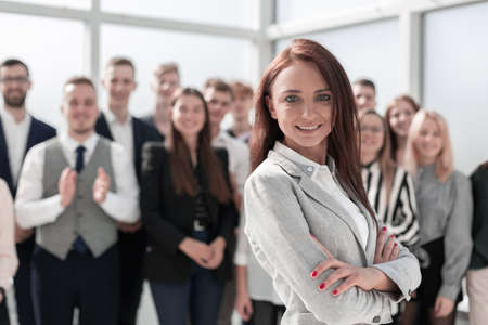 young woman in the background of a group of young employeesの写真素材