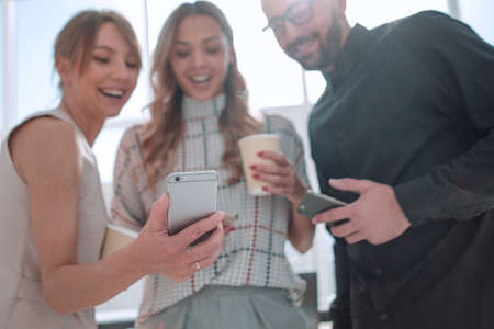 business team reading emails on their smartphones.の写真素材