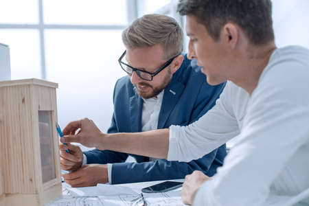 two architects discussing the model of a new projectの写真素材