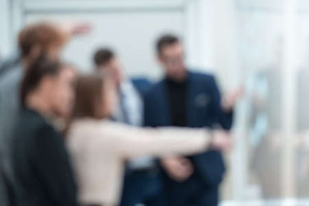 blurry image of a business team standing in the office. business background