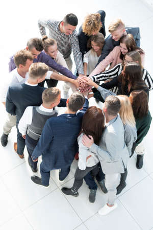 top view. group of young business people showing their unity