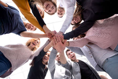 bottom view. a group of young people showing their unity