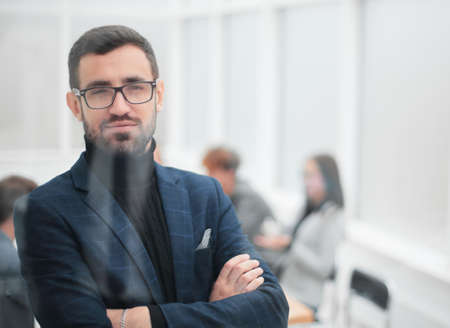 close up. serious business man standing in office.