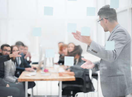 head of the project, pointing to the sticky notes during a work meetingの写真素材