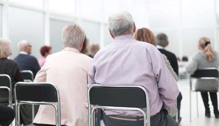 Rear view of a senior people listening a lecture meeting roomの写真素材