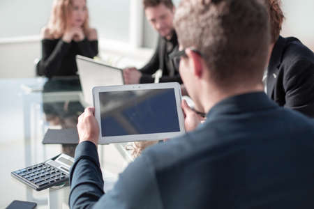 Businessman holding digital tablet, Empty device display mockup, front view. Space upright touchscreen pad gadget hold in armsの写真素材