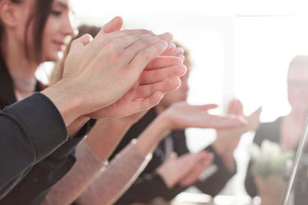 Business people clapping and applause at meeting or conference, close-up of hands.