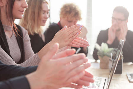 Business people clapping and applause at meeting or conference, close-up of hands.