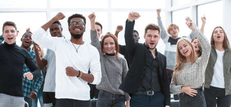 group of happy young people standing with their hands upの写真素材