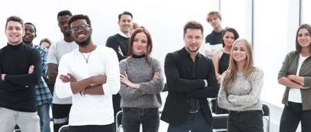 group of confident young people standing in a conference room
