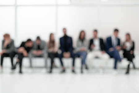 group of diverse young business people looking at their smartphone screens.の写真素材