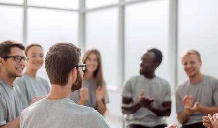 young people are discussing something sitting in a circle.の写真素材