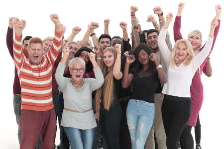 group of happy people standing with their hands up .の写真素材