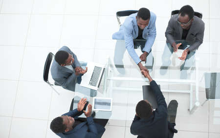 business partners shaking hands during negotiations in the office.の写真素材
