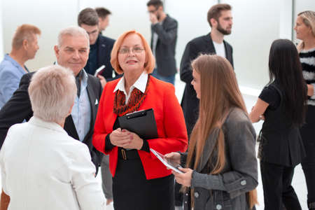 Businesswoman talks with colleagues in office during meetingの写真素材