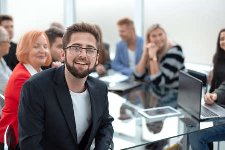 Handsome smiling business man wearing eyeglasses sitting in the meetingの写真素材