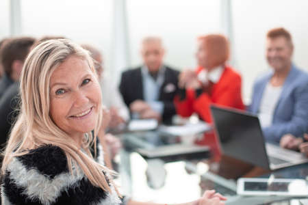 Business woman sitting during a meeting and looking at cameraの写真素材