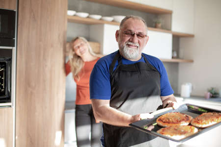 husband and wife standing in the kitchen.の写真素材