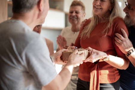 happy woman accepting congratulations from her old friends.の写真素材