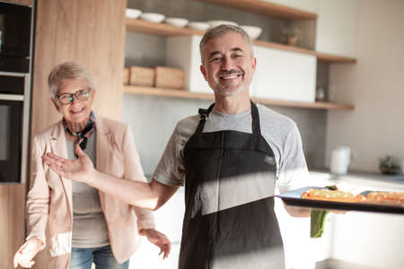 close up. friendly man standing in his kitchen .の写真素材
