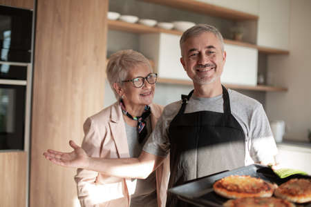 close up. friendly man standing in his kitchen .の写真素材