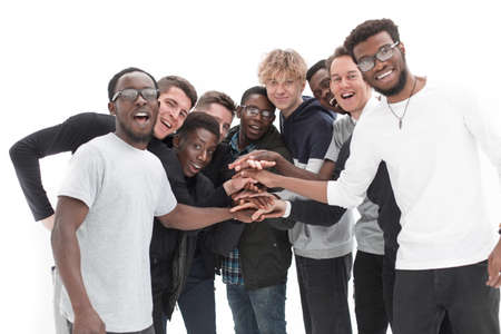 Group of friends in formal clothes putting hands together on whiの写真素材