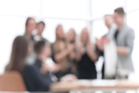 close up. happy working group applauding in the workplace. concept of success