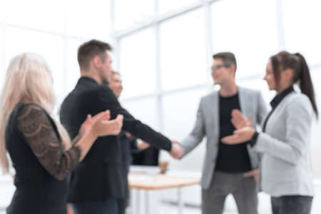 in full growth. handshake of business people in a light office. concept of partnership