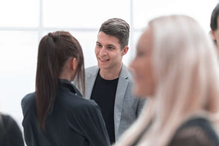 group of young colleagues talking standing in the officeの写真素材