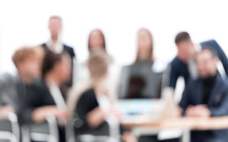 blurry image of a business team sitting at an office Desk. business background