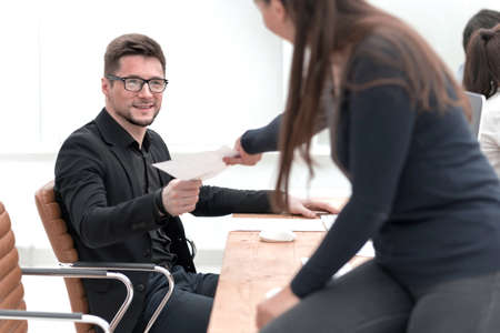 smiling young business woman standing near the desktop