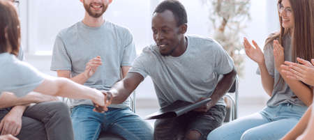 young people greet each other to the applause of their friends.