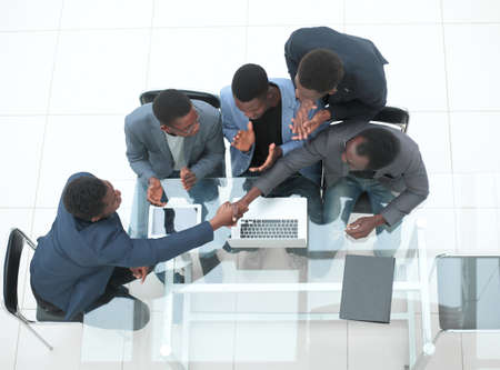 top view. business colleagues shaking hands during office meeting. the concept of cooperation