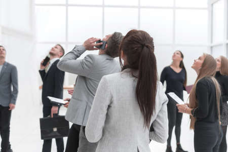 group of different business people passing in the office lobby.の写真素材