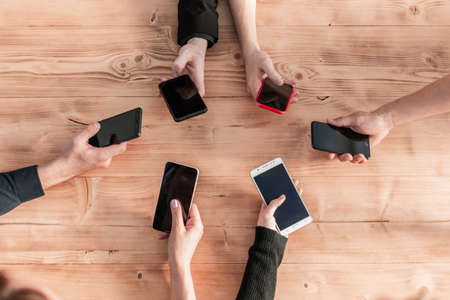 top view businessmen are holding mobile phones