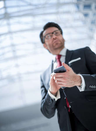 businessman reading text message on smartphoneの写真素材