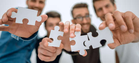 group of young people with puzzle pieces